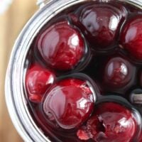 close up shiny cherries preserved in alcohol