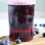 blueberries in a jar with pink lid