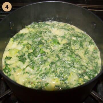 pot of soup with broccoli and spinach cooking on the stovetop.