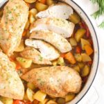 dutch oven chicken with potatoes and carrots seen from above