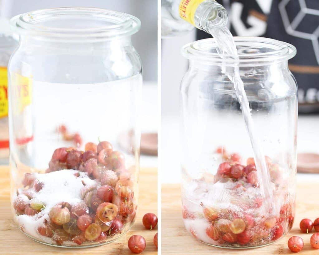 adding sugar to gooseberries in a jar and pouring gin over them