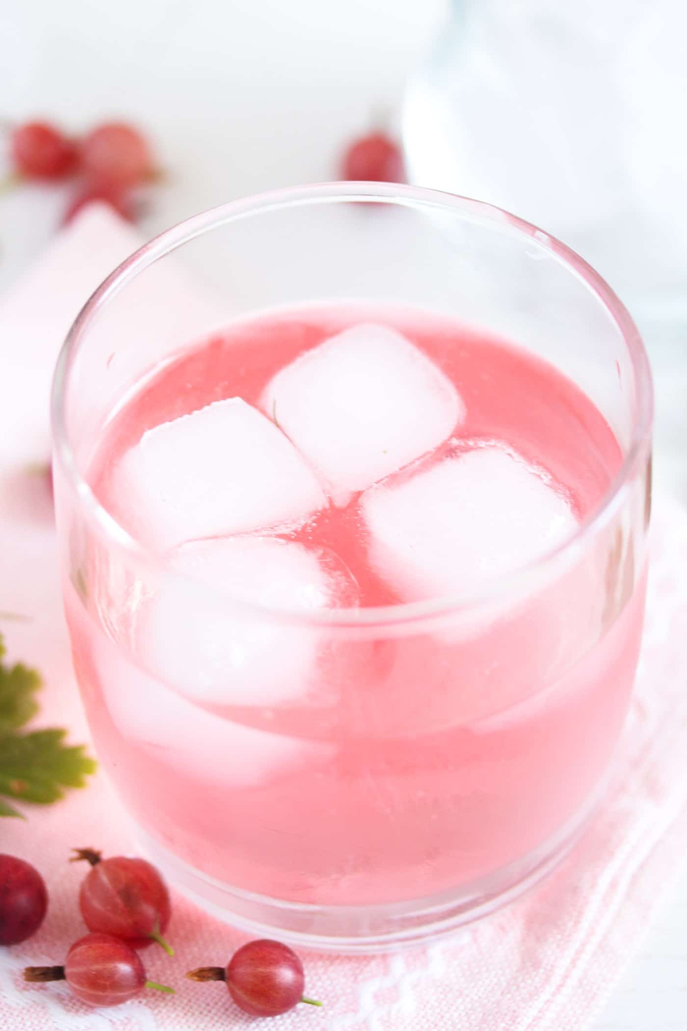 homemade gooseberry gin with ice cubes in a glass