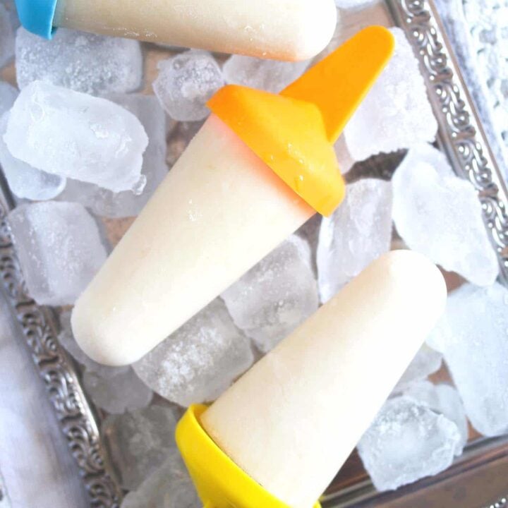 lime popsicles on a silver platter with ice cubes