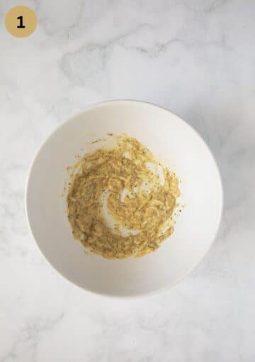 mixture of grated garlic, mustard, and oil in a bowl.