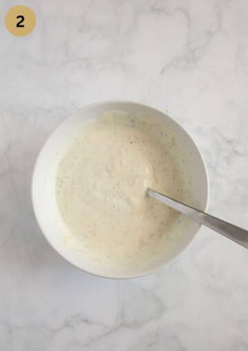 mixture of sour cream, garlic, and mustard in a bowl.