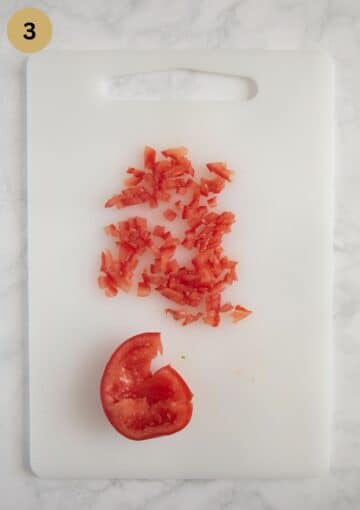 finely chopped tomatoes on a cutting board.