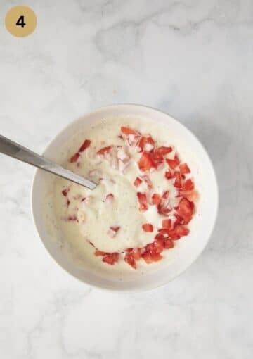 mixture of sour cream, tomatoes, and garlic in a bowl.