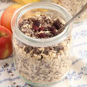 jar full of homemade sugar-free muesli with a spoon sticking into it.