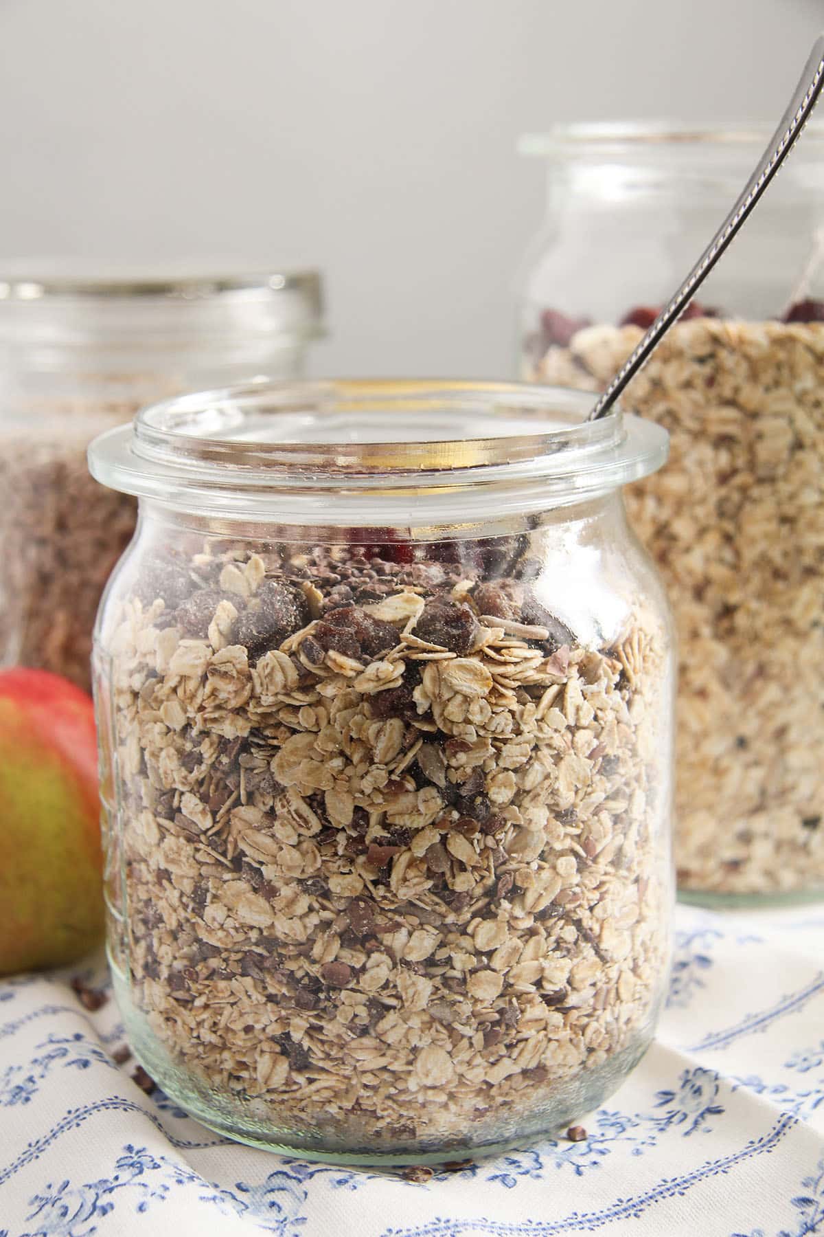 one large jar full of homemade muesli with a spoon in it.