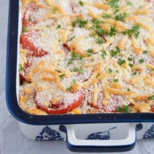 tuna pasta bake sprinkled with breadcrumbs and parsley in a baking dish.