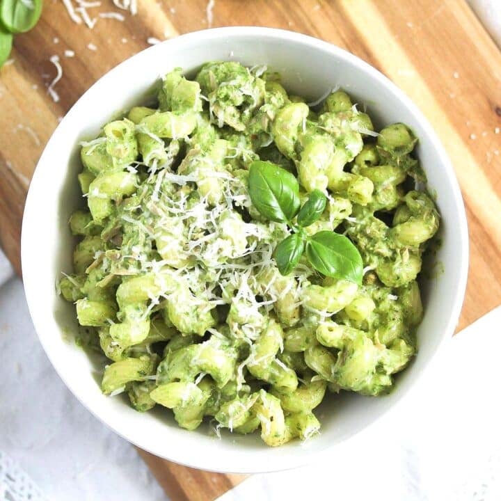 tuna pesto pasta sprinkled with parmesan in a white bowl seen from above