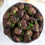 bowl full of turkish kofta sprinkled with fresh parsley.