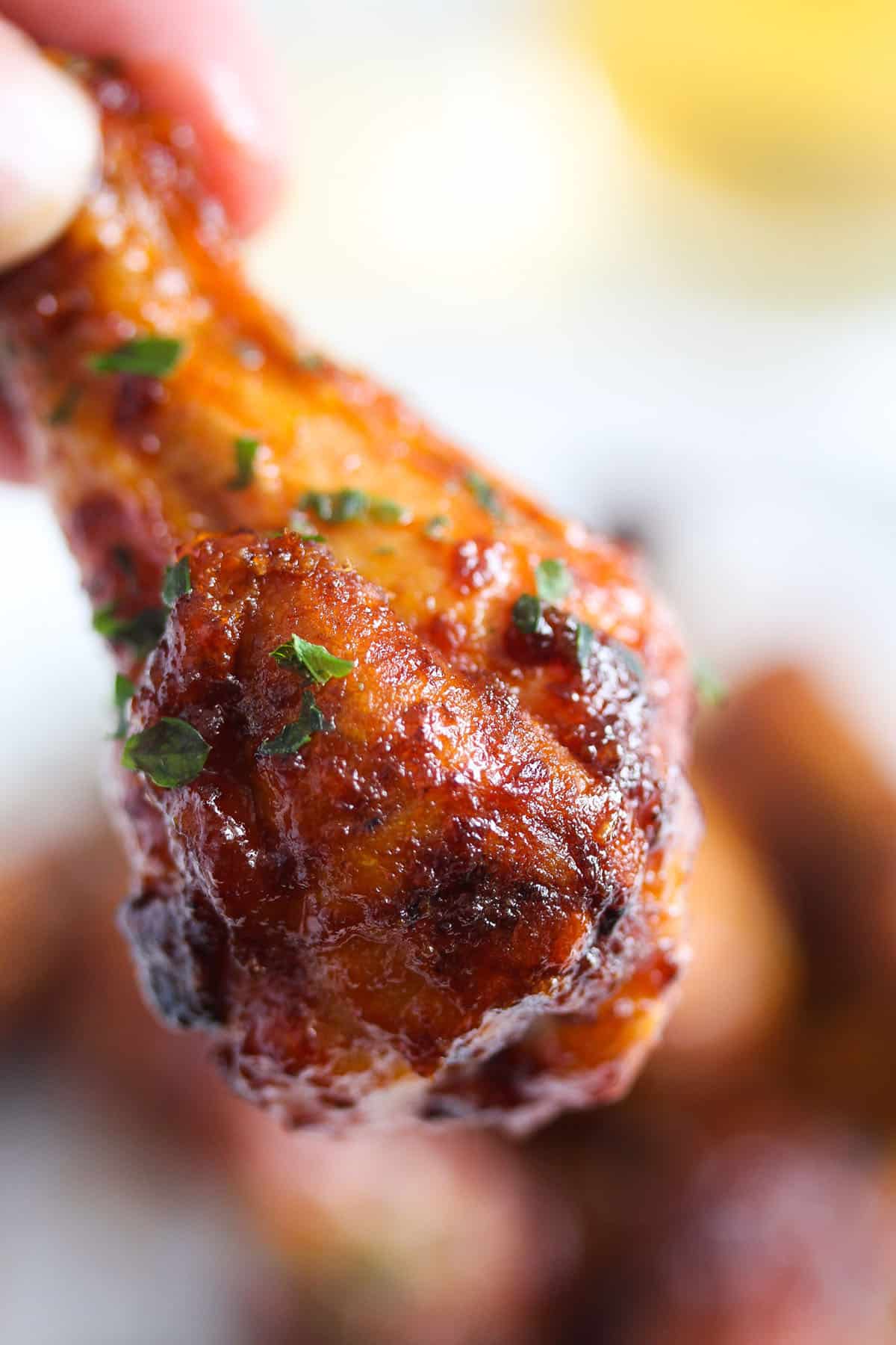 one golden drumsticks cooked from frozen and held by a hand.