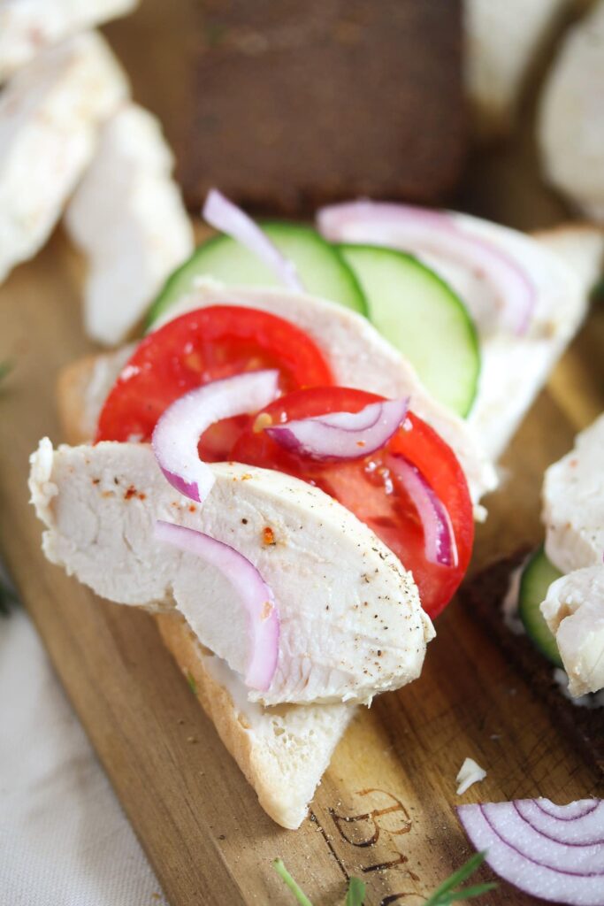 poached chicken sandwich with tomatoes and cucumbers