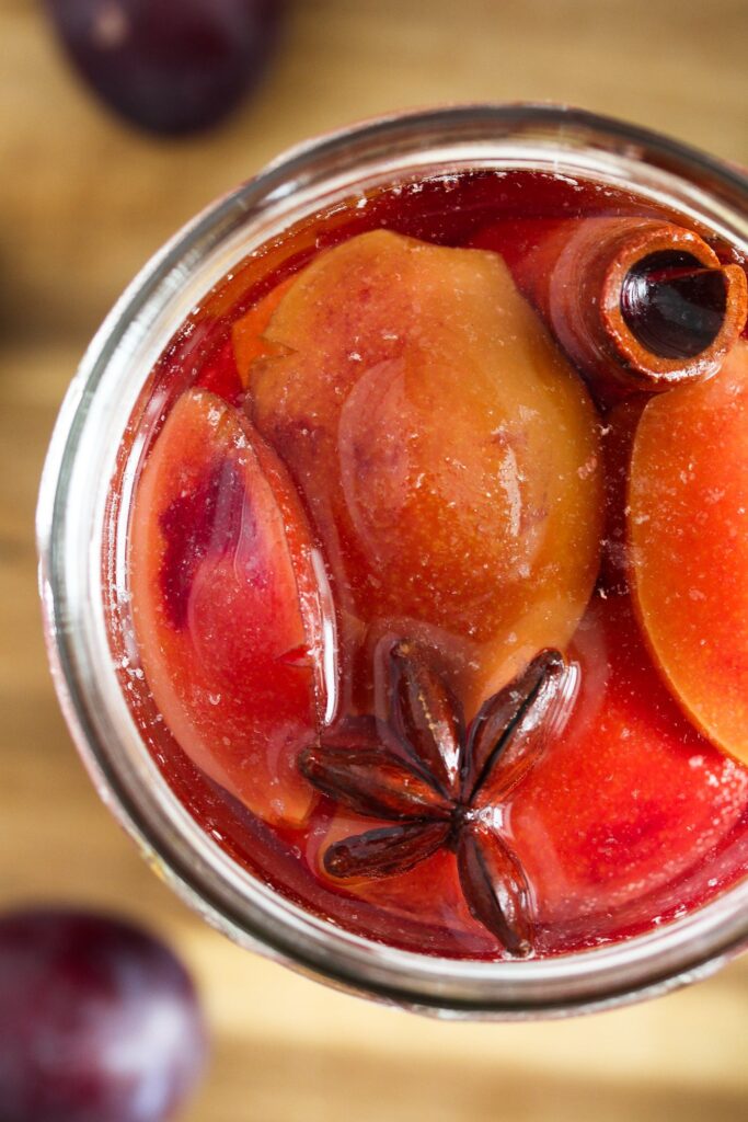 jar of preserved fruit with cinnamon and anise star seen from above