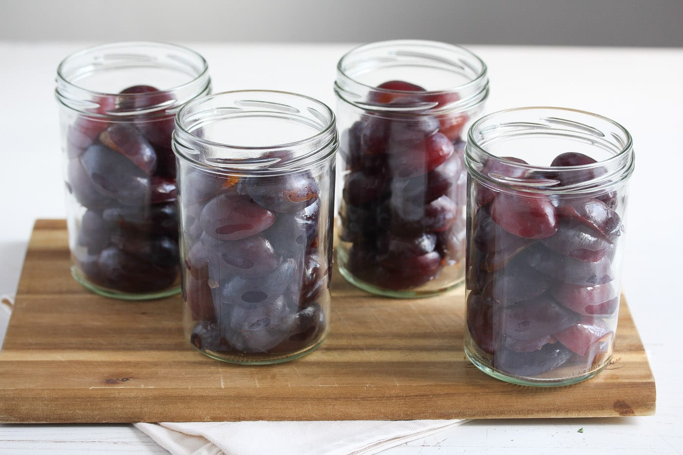 raw italian plums halved and packed in jars