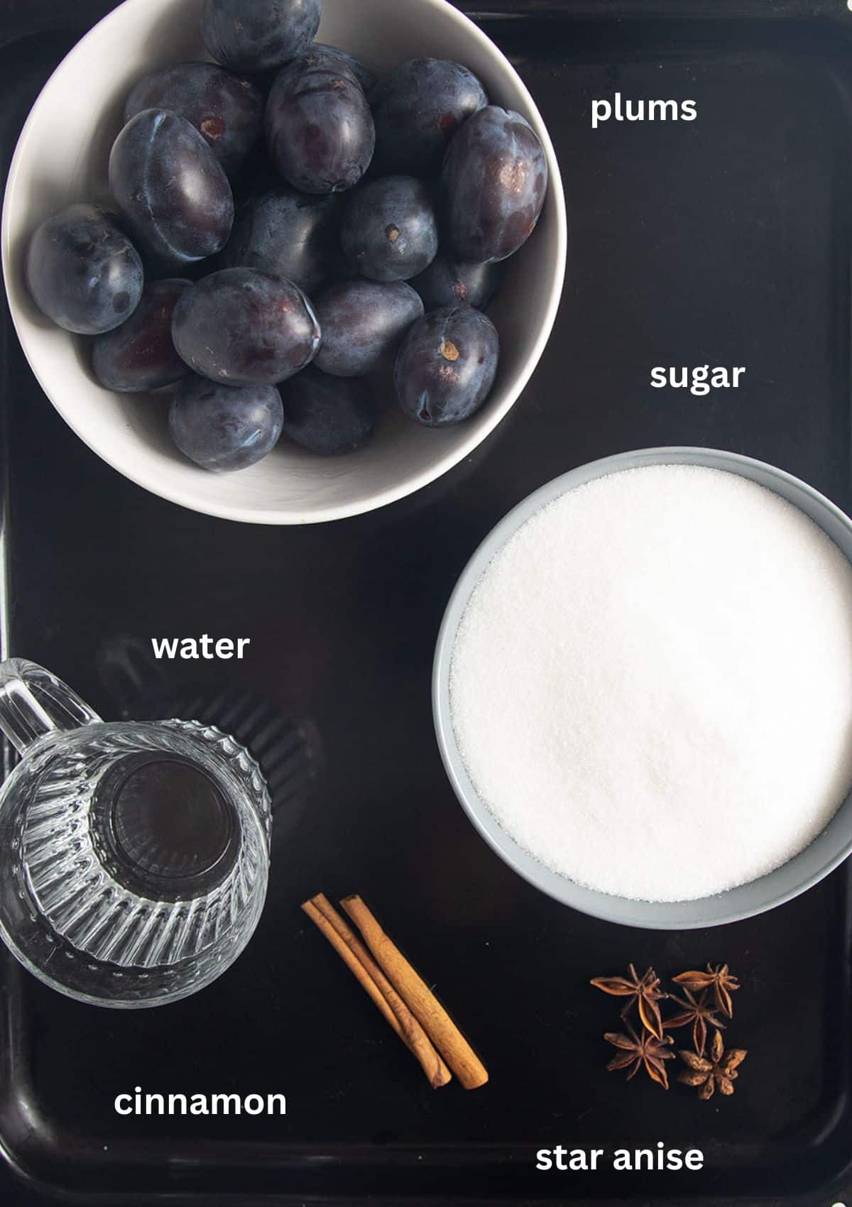 labeled ingredients for canning plums with sugar, water, cinnamon and star anise.