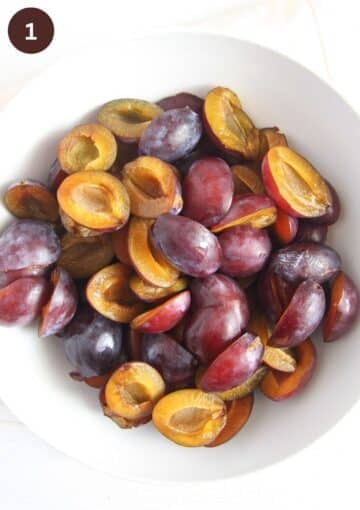 halved italian plums in a large bowl.