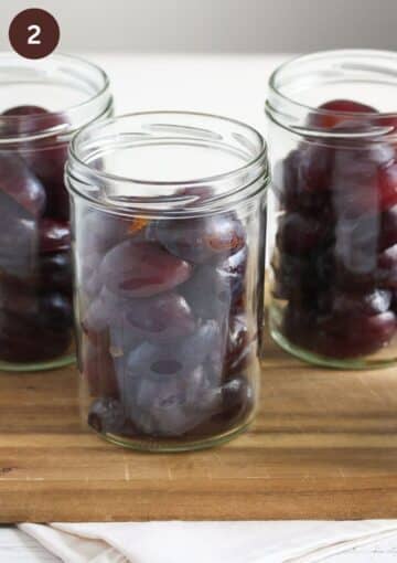 small, halved plums stuffed into jars before adding the canning liquid.
