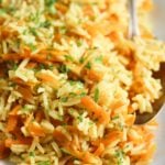 curry rice with grated carrots on a large platter