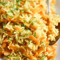 curry rice with grated carrots on a large platter