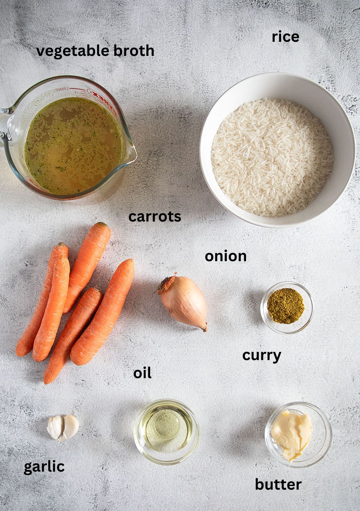 labeled ingredients for making rice with carrots, broth and curry powder.