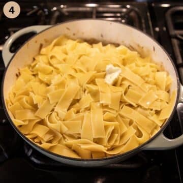 wide noodles added to a large pot of cabbage.