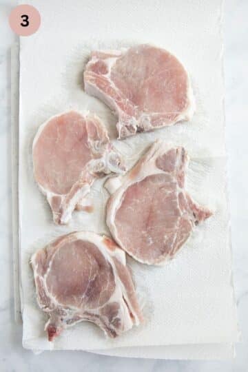 drying milk marinade from pork chops with paper towels.