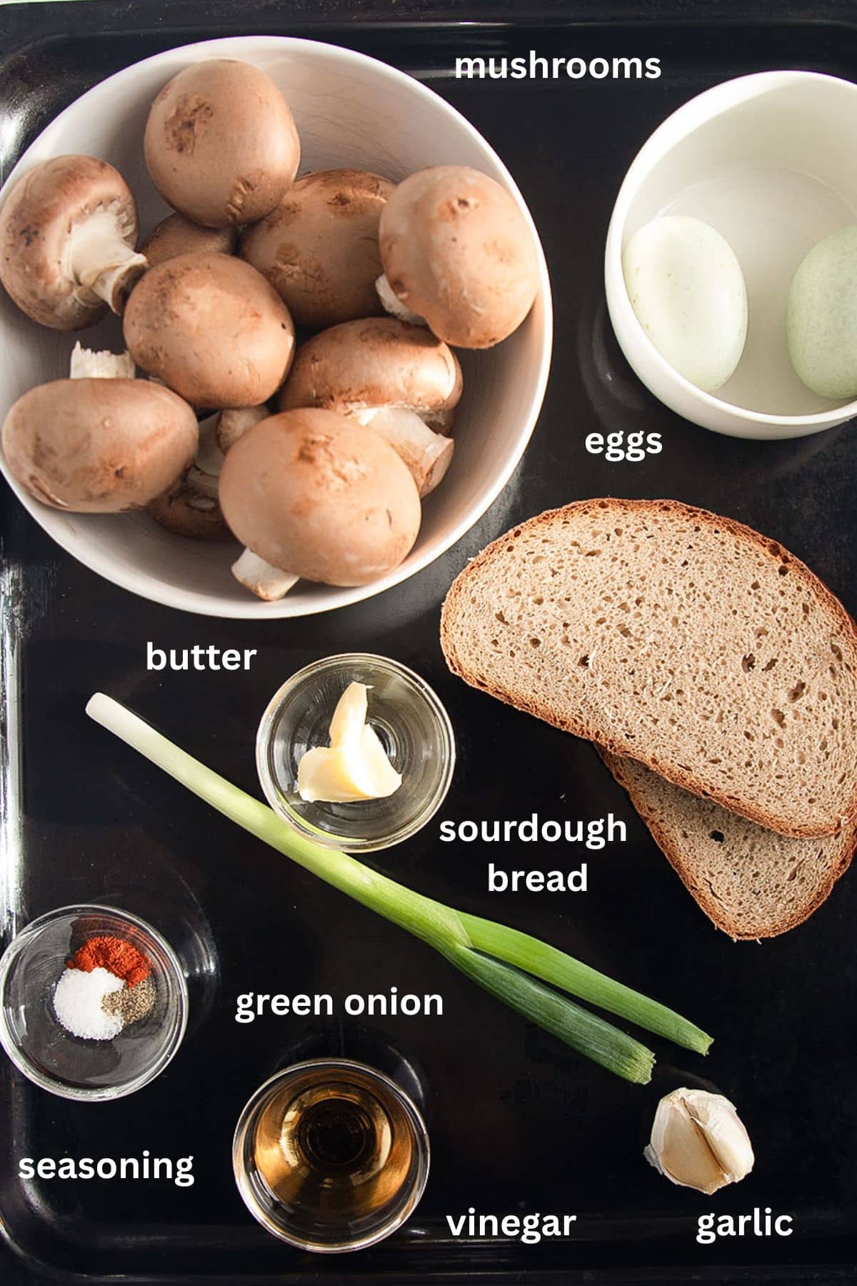 labeled ingredients for making mushroom toast with poached egg and sourdough bread.