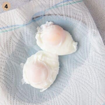 two poached eggs draining on paper towels.