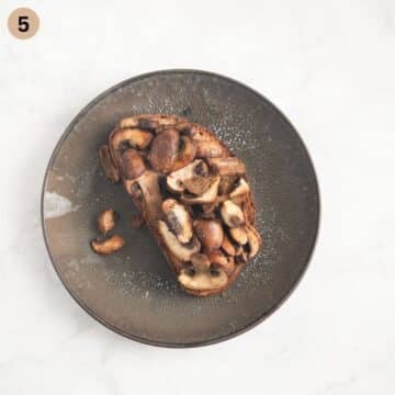 topping a toast with sauteed mushrooms.