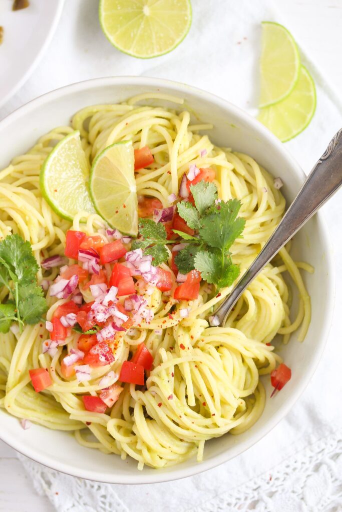 tangled spaghetti with sauce and tomatoes in a bowl