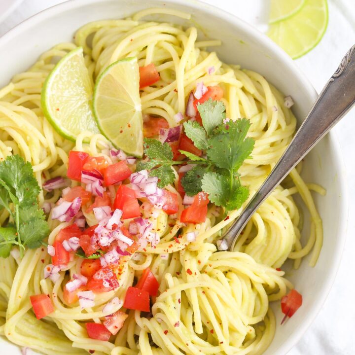 tangled spaghetti with sauce and tomatoes in a bowl