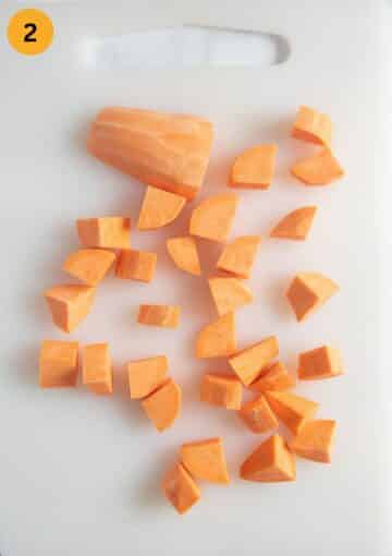 chopped sweet potatoes for soup on a cutting board.