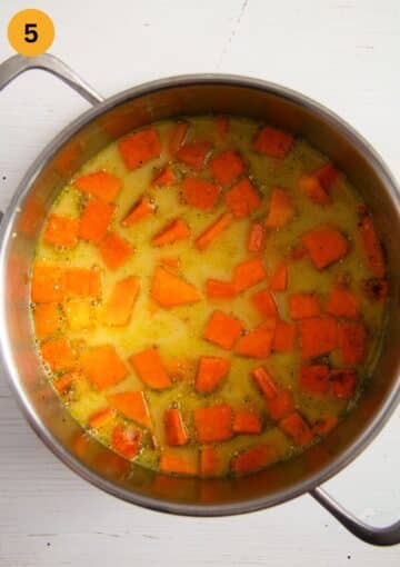adding broth and coconut milk to sauteed sweet potatoes and pumpkin to make soup.