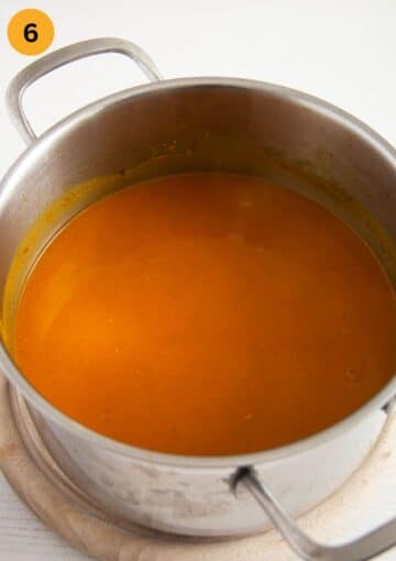blending creamy pumpkin and sweet potato soup until smooth.