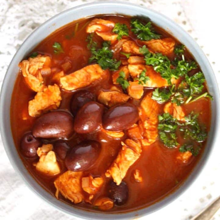 bowl of ras el hanout chicken stew with olives.