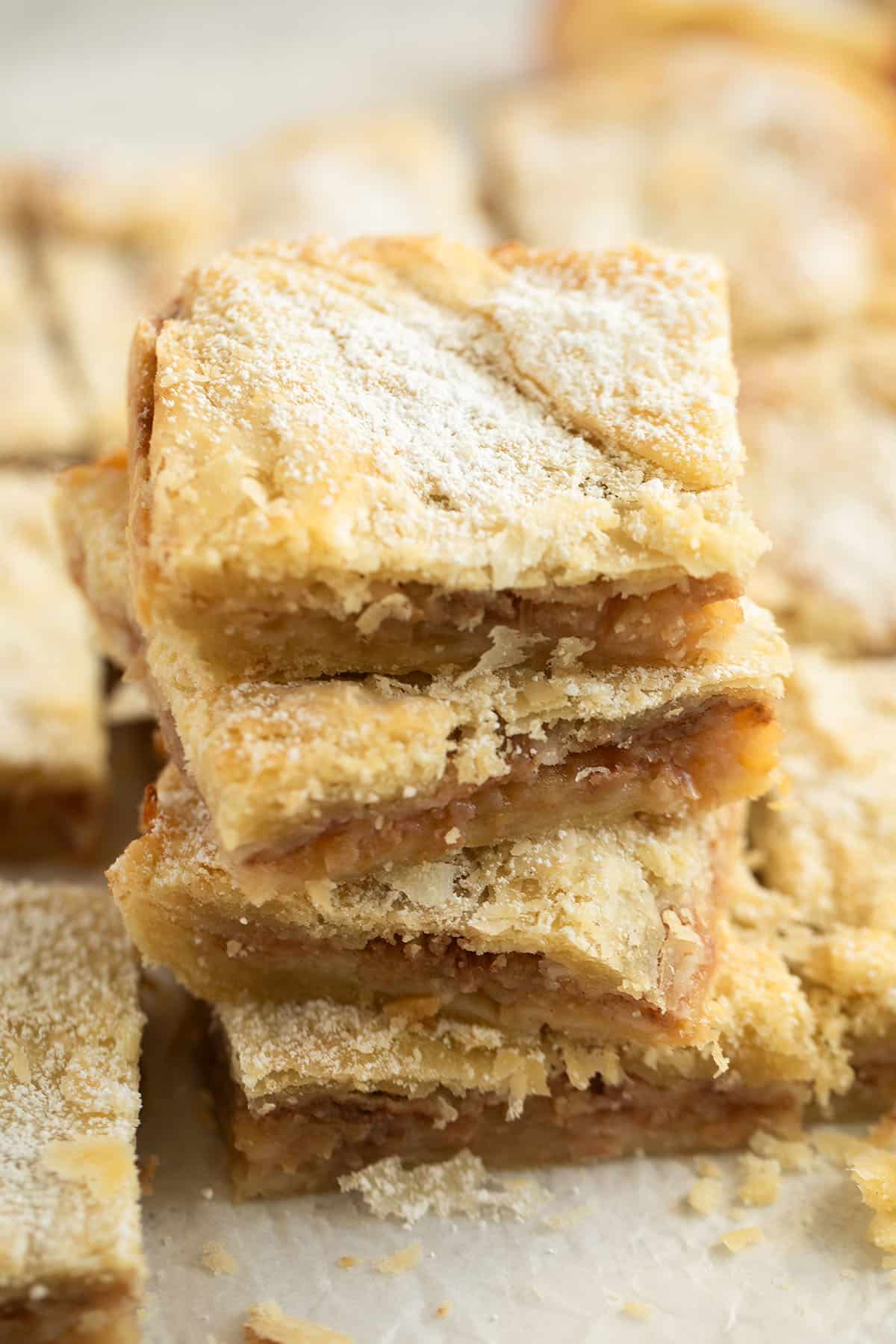 stacked squares of romanian pie with thick apple filling.