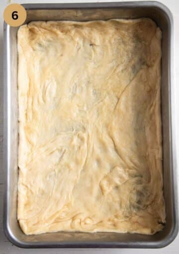 rolled pie dough in a baking tin before baking.