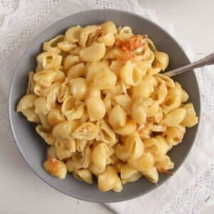 romanian mac and cheese in a grey bowl.