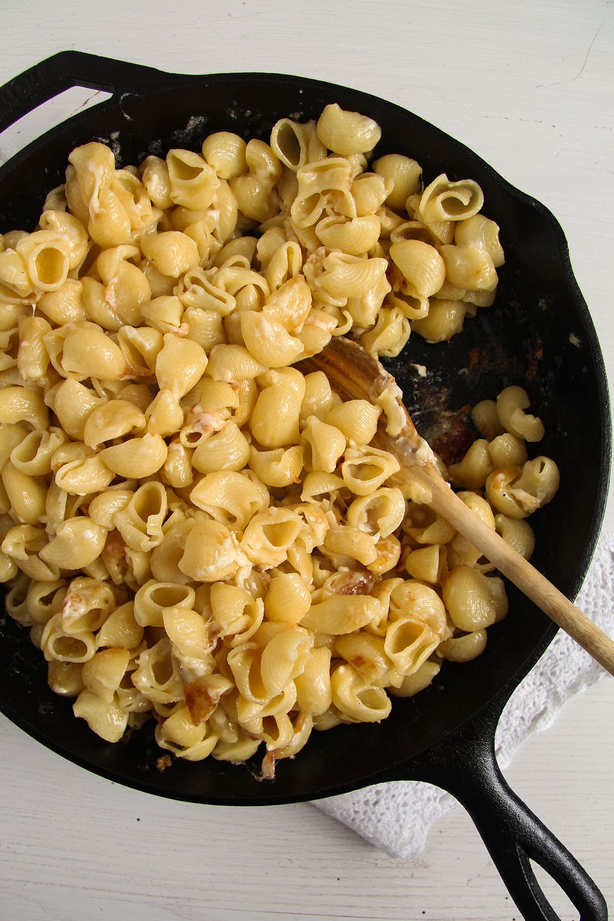 romanian mac and cheese with feta in a cast iron skillet. 