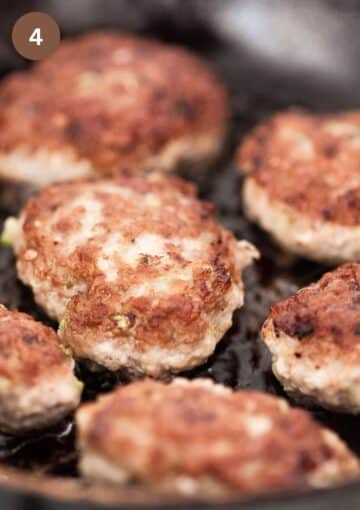 frying large meatballs in a pan.