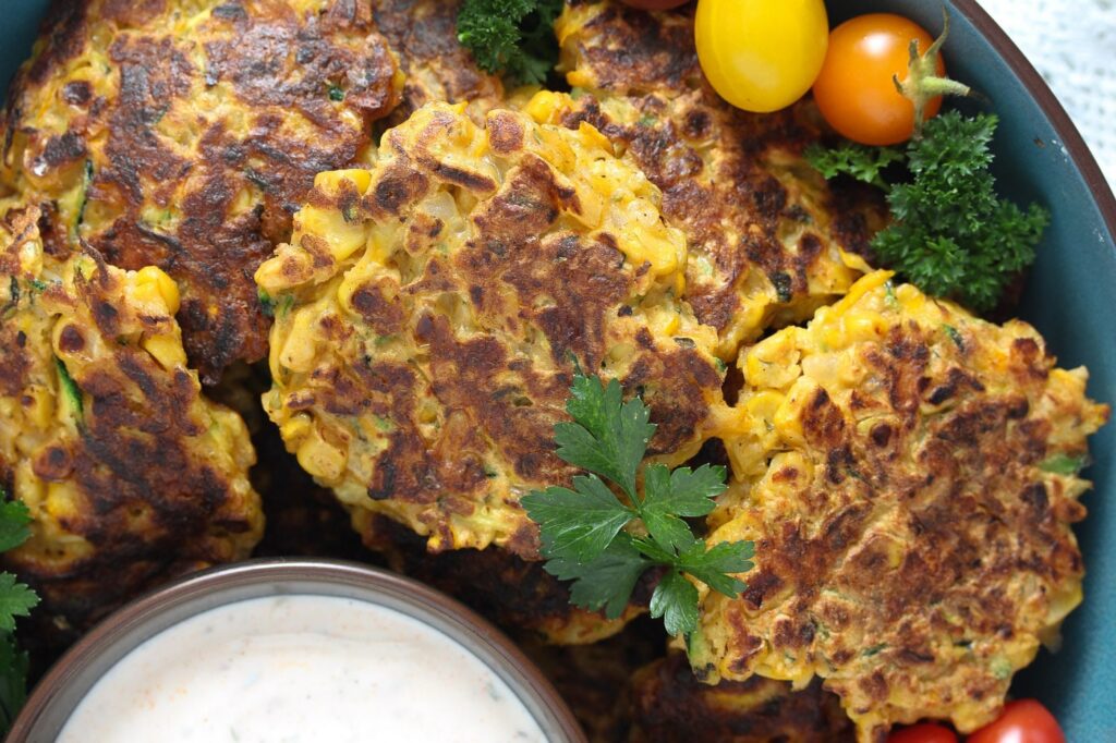 vegetable patties served with yogurt dip and tomatoes