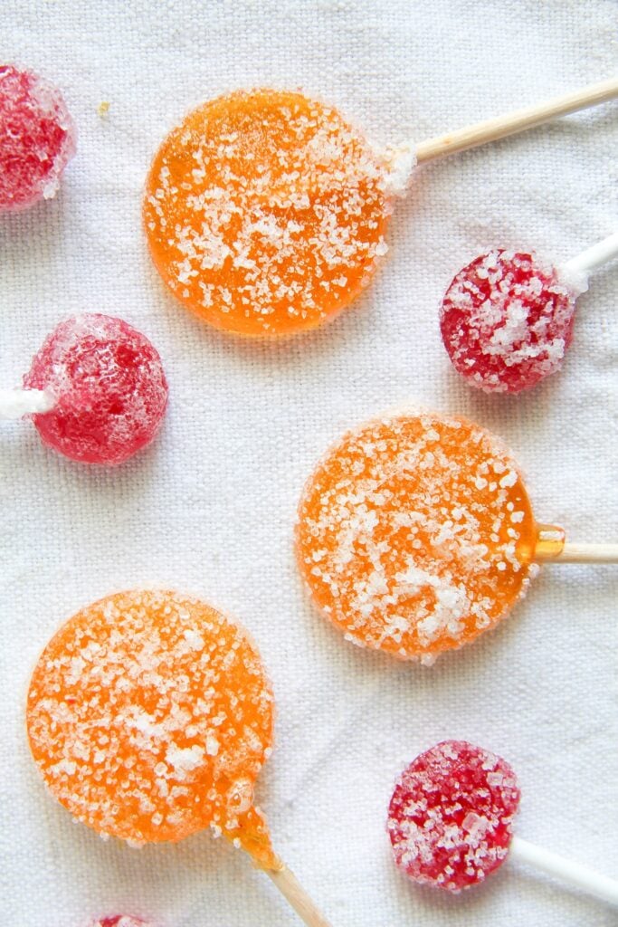 orange and red lollies on a white table cloth