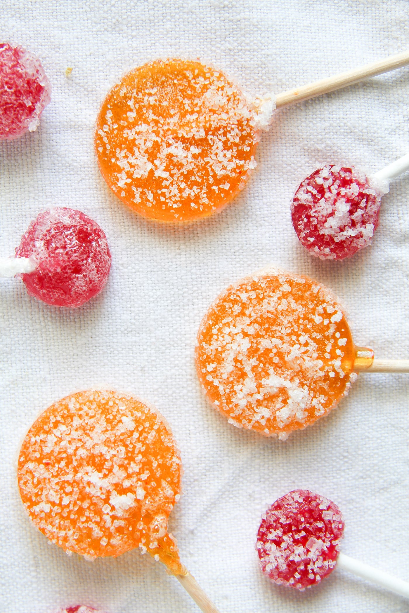 orange and red lollies on a white table cloth