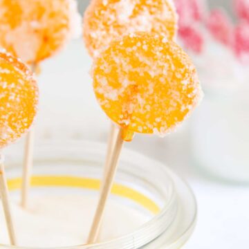 orange lollies in a jar coated with acid coating