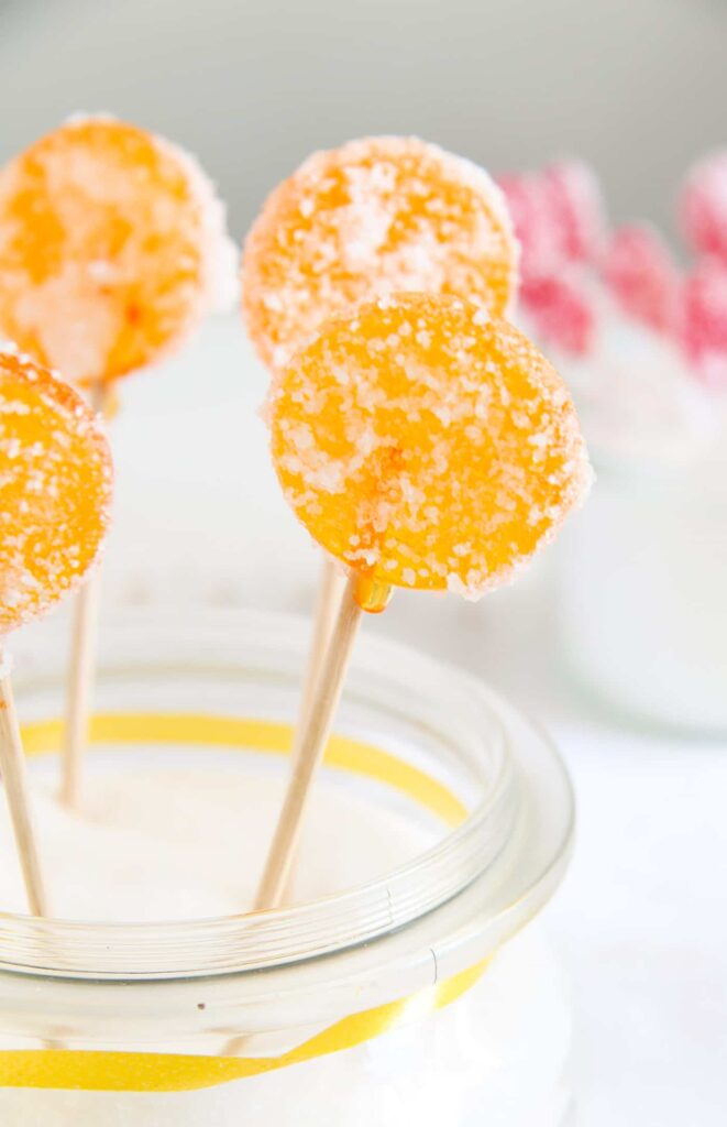 orange lollies in a jar coated with acid coating