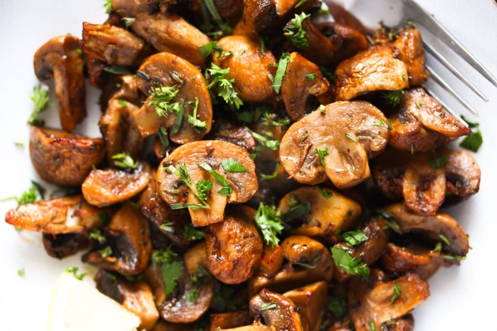 close up of sliced fried mushrooms with parsley