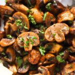 close up of sliced fried mushrooms with parsley