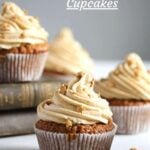 cupcakes topped with whipped cream frosting and sprinkled with golden stars